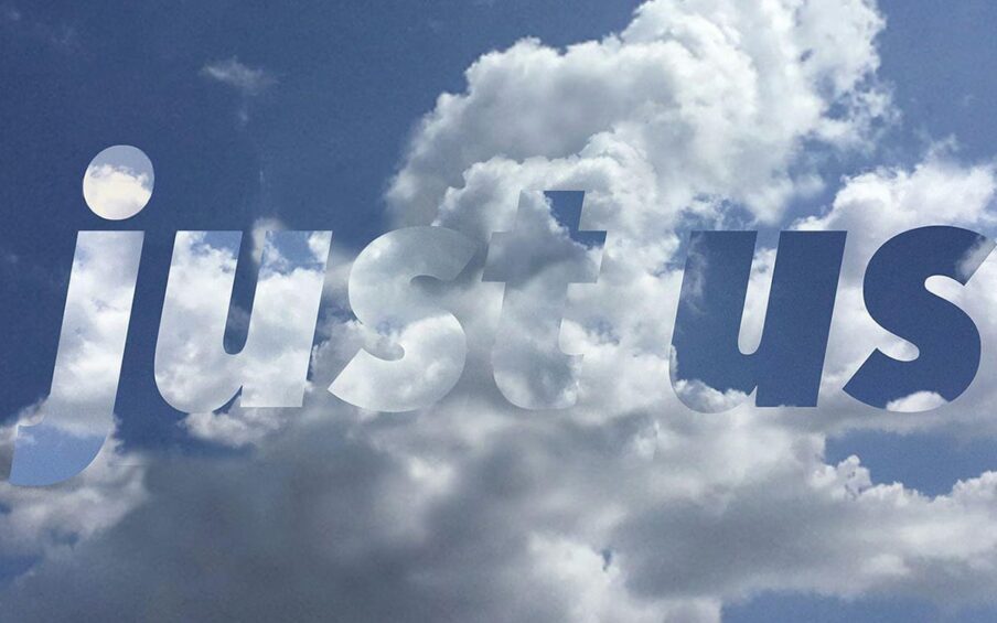 A square photo with a background of blue sky and fluffy, white clouds. Superimposed over this are the words “just us” using a thick font that features more blue sky and white clouds. Along the bottom edge are the words “Plan Your Vote.org”. “Plan” and “Vote” are in white font, “Your” and “.Org” are in dark blue font.