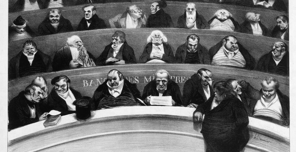 Le Ventre législatif: Aspect des bancs ministériels de la chambre inprostituée de 1834 (The Legislative Belly: Aspects of the Prostituted Ministerial Benches of 1834), Honoré Daumier, 11 1/8 in x 17 1/8 inches, Lithograph on wove paper. A horizontal, rectangular black and white print showing rows of men sitting in curved, tiered seating. The four rows are stacked one upon another showing how each row is higher than the one below it. Each row is packed with between seven to ten older men, most having narrow shoulders and broad middles, dressed in dark coats and the high white collars of the time. The waist high railing allows only their upper bodies to be visible. Some confer with heads together or are turned to speak to each other, some appear to be dozing. At lower right, one large man dressed in black with shaggy hair stands in front of the bottom railing turned to the left, his arm resting on the railing. At left, a top hat and a book also rest on the railing.
