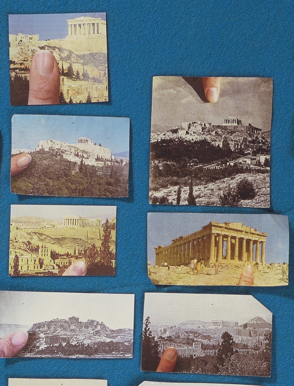 Detail: View of the artwork showing two vertical rows of images. The first row contains four pictures of the Acropolis, the first three in color and the last in black and white. The second row has three clippings, the first and last in black and white and the third in color. Each show the Acropolis from a different viewpoint, close-up or from afar. They also contain the image of a fingertip.