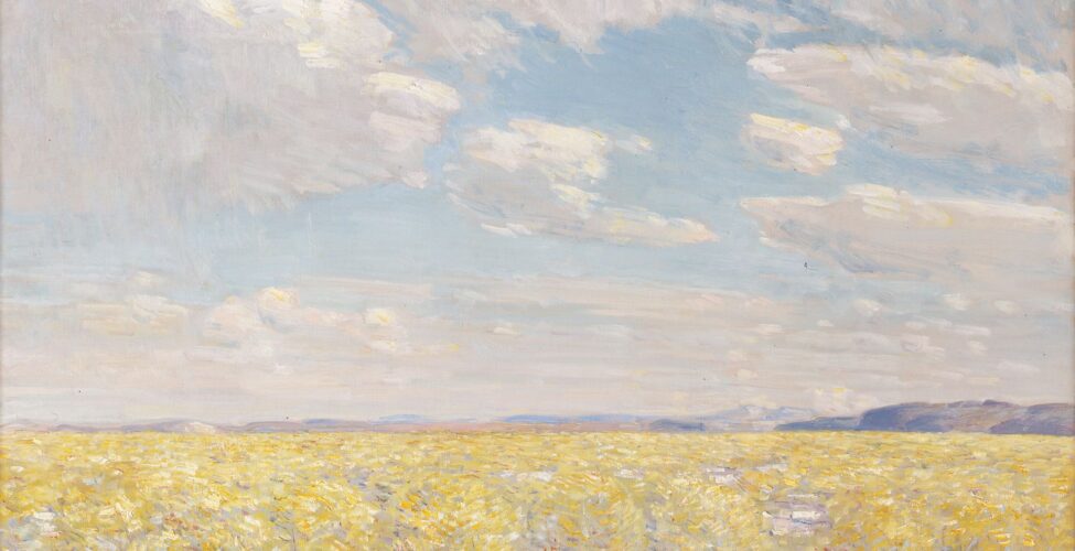 Afternoon Sky, Harney Desert. Childe Hassam. 1908. Oil on canvas. 20 ⅛ in x 30 ⅛ in. Landscape painting of the desert in Harney County, Oregon. The foreground is covered with short, sharp, yellow and white brushstrokes with orange and red highlights that make up the desert foliage resembling sage brush. Beyond the desert, near the middle of the painting, soft blue and purple lines show the distant mountains. Above them the sky fills the top two thirds of the painting. The blue sky is filled with both large banks of clouds and a few single oval-shaped clouds in the middle. The clouds appear light gray and white with soft yellow highlights along the edges. From a distance, the painting portrays a soft, warm view of the landscape. A close view reveals distinct short strokes and the blending of multiple colors.