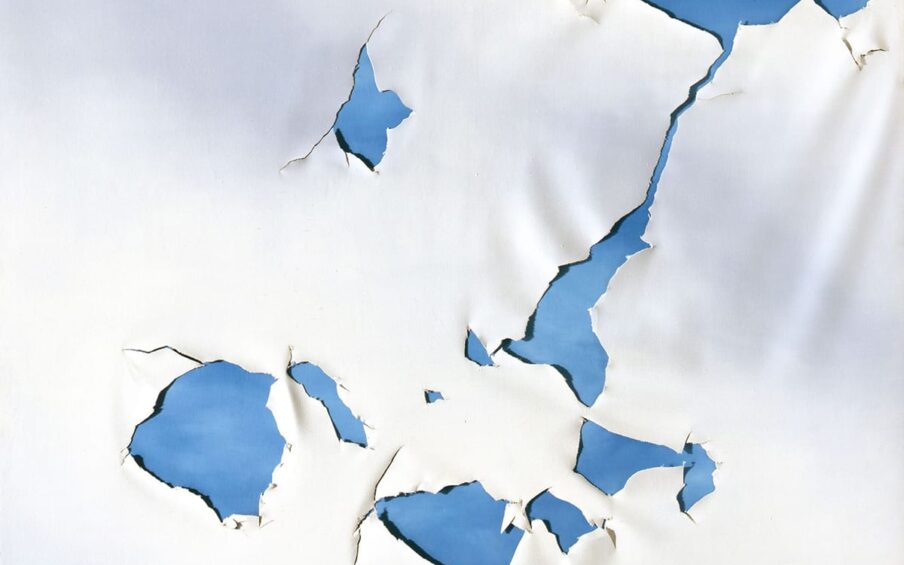 Torn Cloud Painting, Joe Goode, 60 x 60 inches, oil on canvas. A square work showing a white canvas torn to reveal a deep sky blue canvas beneath it. The tears begin in the upper right corner with a small roughly crescent shaped tear and a larger irregular jagged tear that connects via a narrow, crooked fissure to a triangular tear near the center of the work. Three more tears are located below and another two slightly above and to the left. Smaller diamond-shaped tears appear at upper center left and lower left. The edges of the tears are ragged with the canvas fraying in spots. Shallow folds of loose canvas are visible as the material sags in spots. These create shadows in addition to the ones made on the blue canvas by the gaping holes.