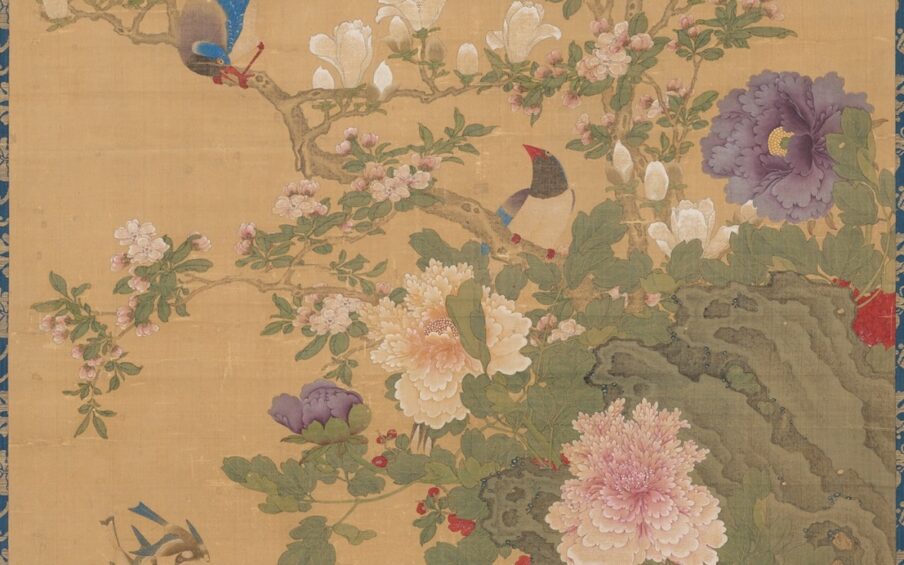 Image description: Birds and Flowers, Sun Yi, hanging scroll; ink and color on silk, painting: 48 1/2 x 27 3/4 inches; mounting; 92 1/2 x 34 inches. Detail of scroll depicting two birds perched on flowering branches. A brown bark covered branch bisects the work from upper left slanting down the lower right. A male bird grips the branch at left, grey plumed tail held high while it bows its blue capped head at its mate at lower right. Its wings are bright blue, body gray and beak, legs and feet a brilliant red. They perch among creamy white magnolia blossoms and buds, tiny pale pink crabapple blossoms and leafy greenery. A large peach magnolia blossom with its many layered, ruffled petals is at lower bottom next to a violet peony bud. The scene is set against a khaki background.