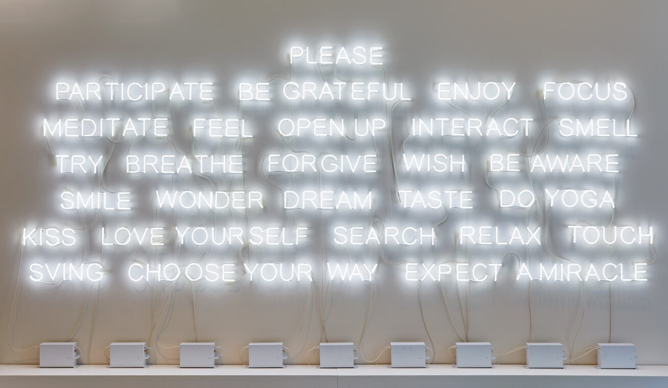 White neon text on a wall.