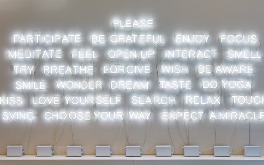White neon text on a wall.