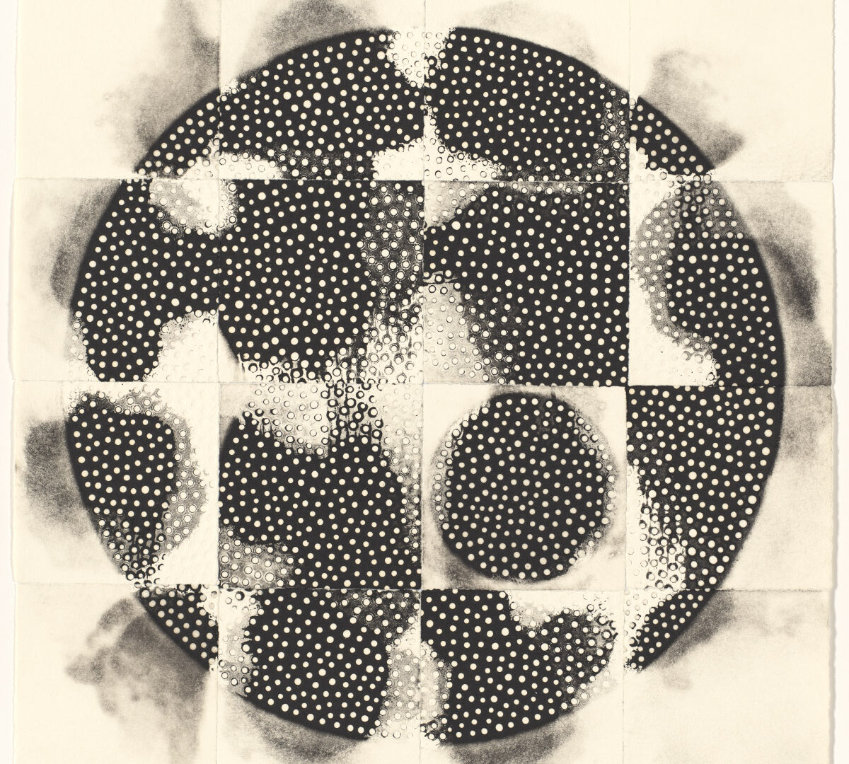 This black and white monoprint is composed of a series of 16 separate 3-inch squares assembled in four rows of four squares each with the white background forming a border around the whole assemblage. In a mosaic-like arrangement, the 16 white squares make up one larger square that forms a central image of a circle. Smoky greyish black shadows emanate from each edge of the circle. Most of the individual squares making up the circle are printed with black shapes that almost resemble jigsaw pieces. On the near bottom right side, a full circle appears in one of the squares, in contrast to the jagged forms in the other squares. The black forms are broken up with tiny white polka dots. While some dots appear flat against the dark background, other dots appear as if embossed with raised edges.