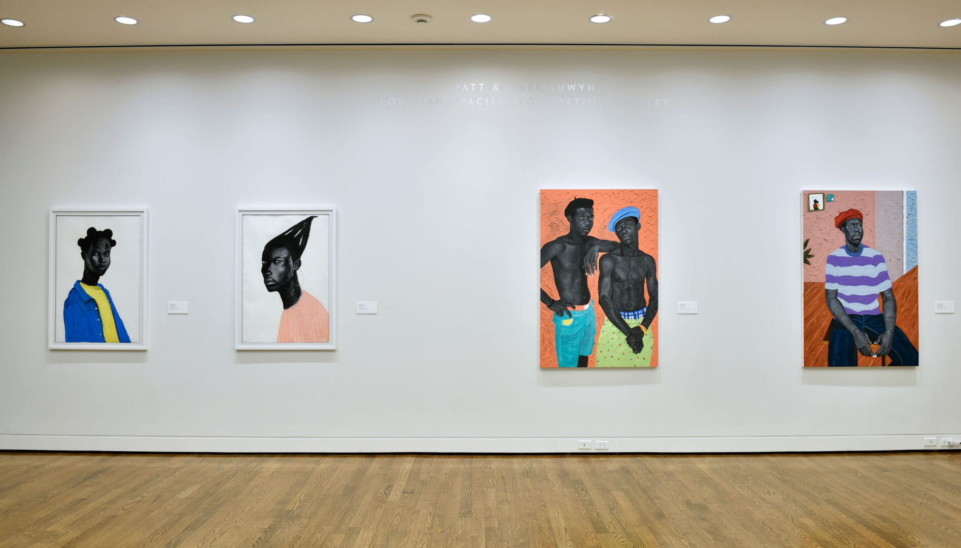 Gallery wall with four paintings by Otis Quaicoe.