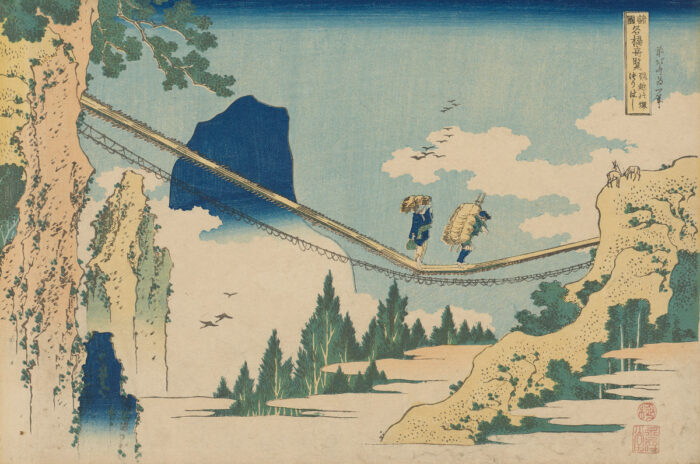 Woodcut print of two figures walking over a suspension bridge with mountains, trees, and clouds surrounding them