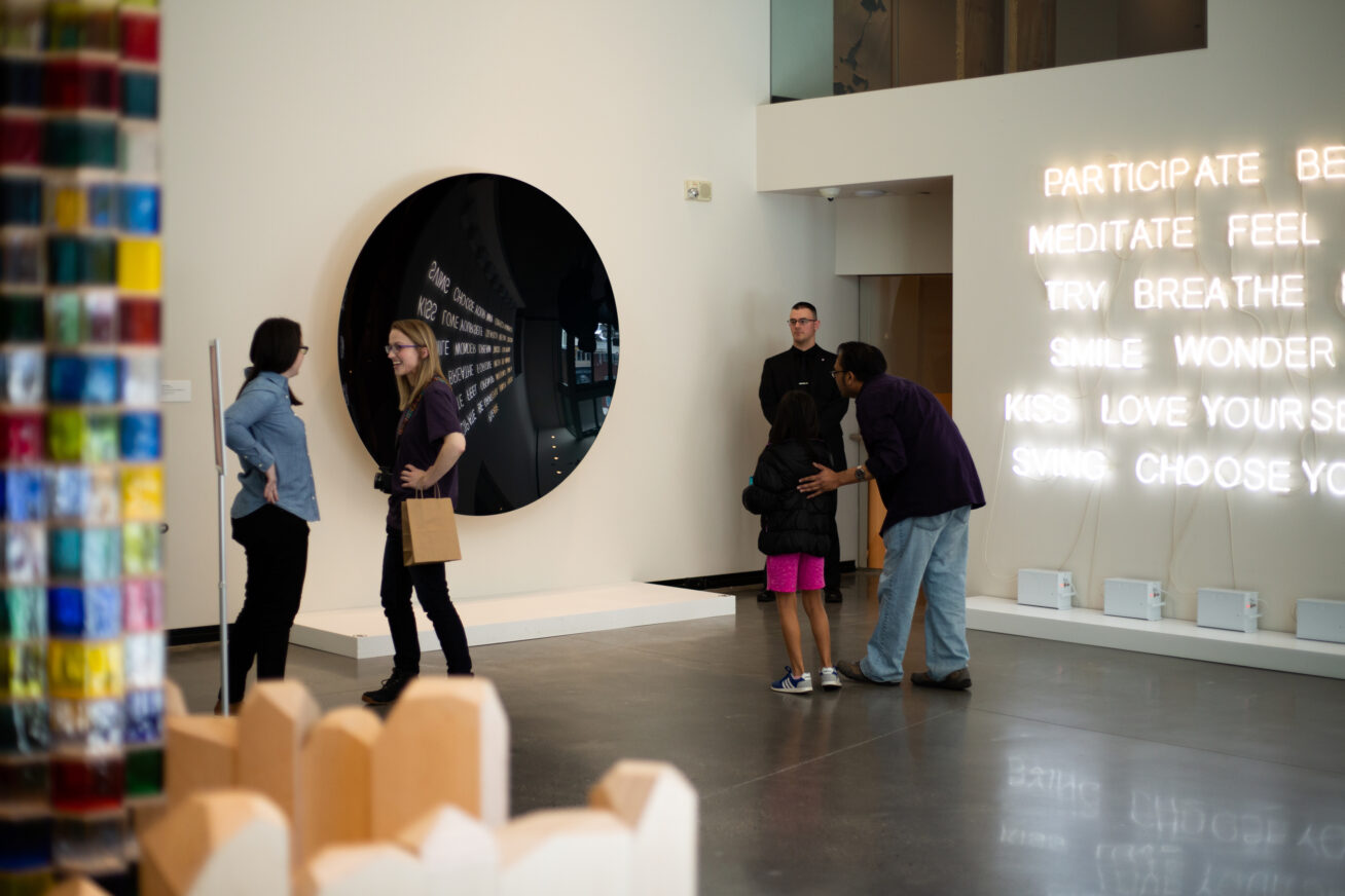 Photo of a contemporary art gallery in the Museum with visitors looking at the art.