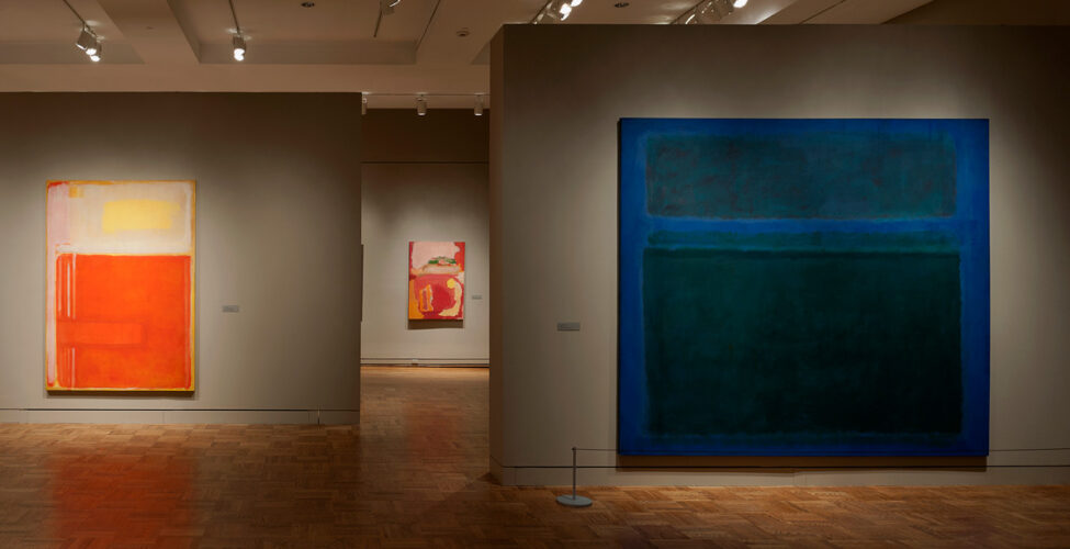Dimly lit gallery with Mark Rothko paintings
