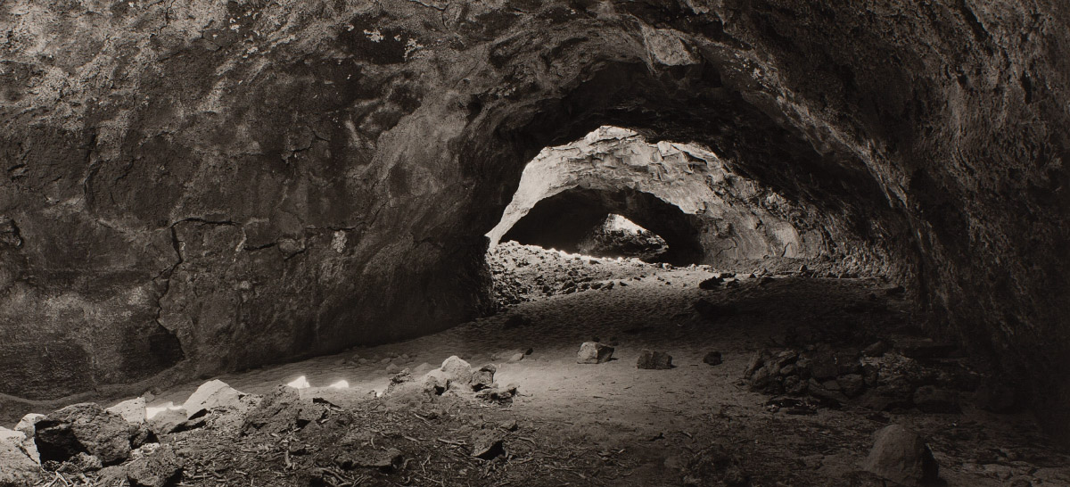 Black and white photograph of the inside of a cave