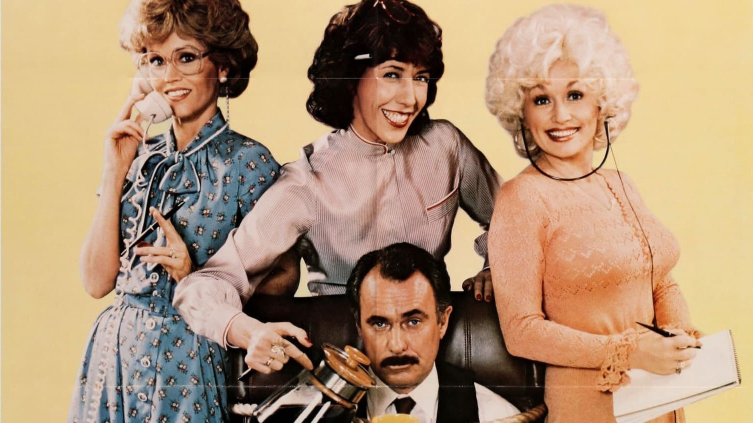Film poster for 9 to 5 with three woman standing behind a man tied to his desk chair