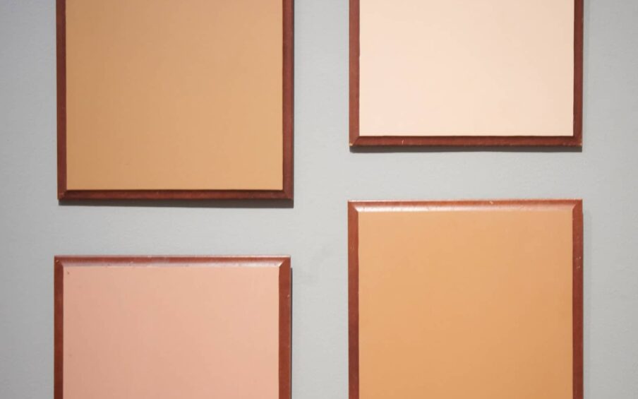 Four framed panels of different colors on a wall.