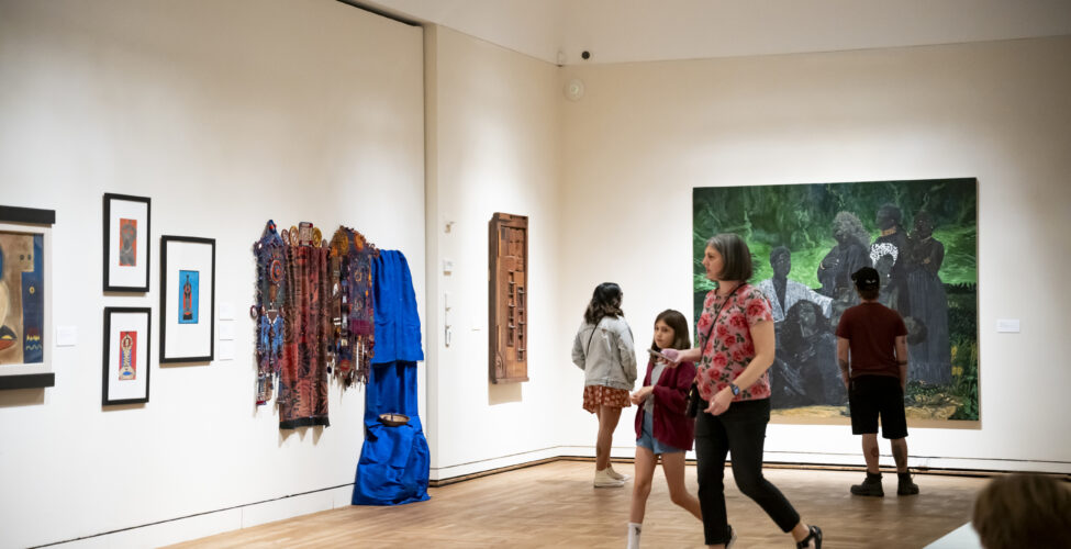 People walking around the Black Artists of Oregon gallery