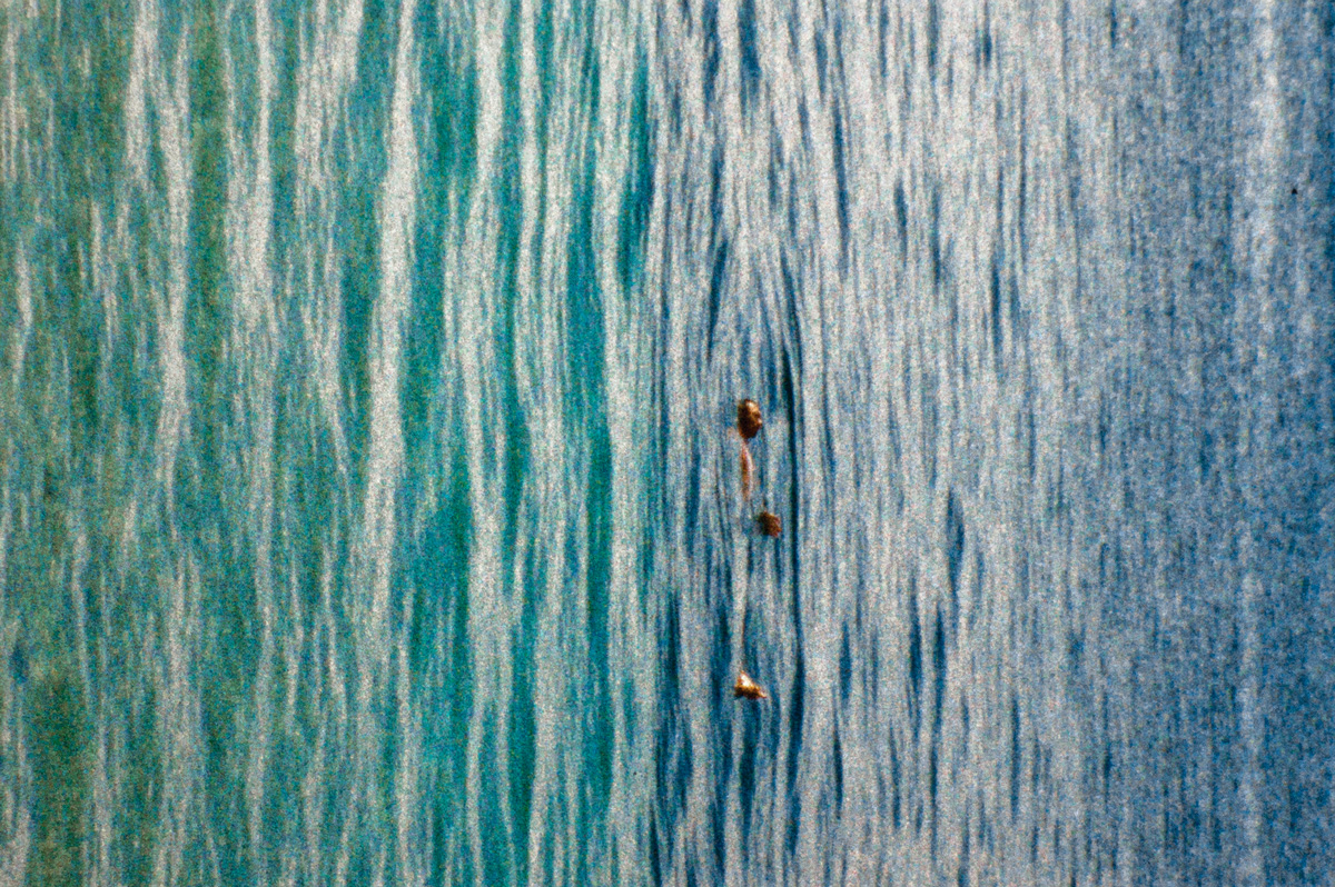 Film still of a person floating on water, turned 90 degrees clockwise
