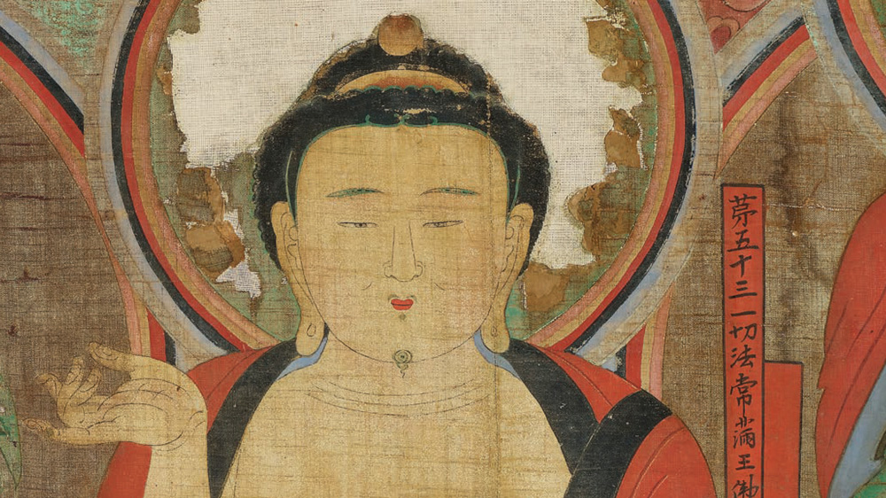 Close up image of a Buddha head painting