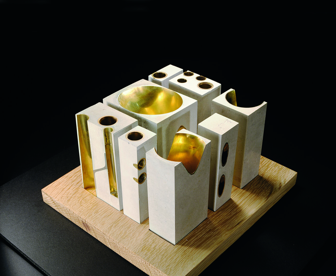 Photo of a study for a building made out of brass and concrete.