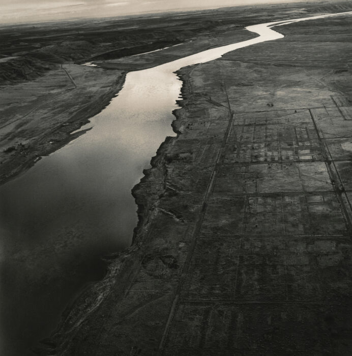 Black and white photo of a river and the surrounding land