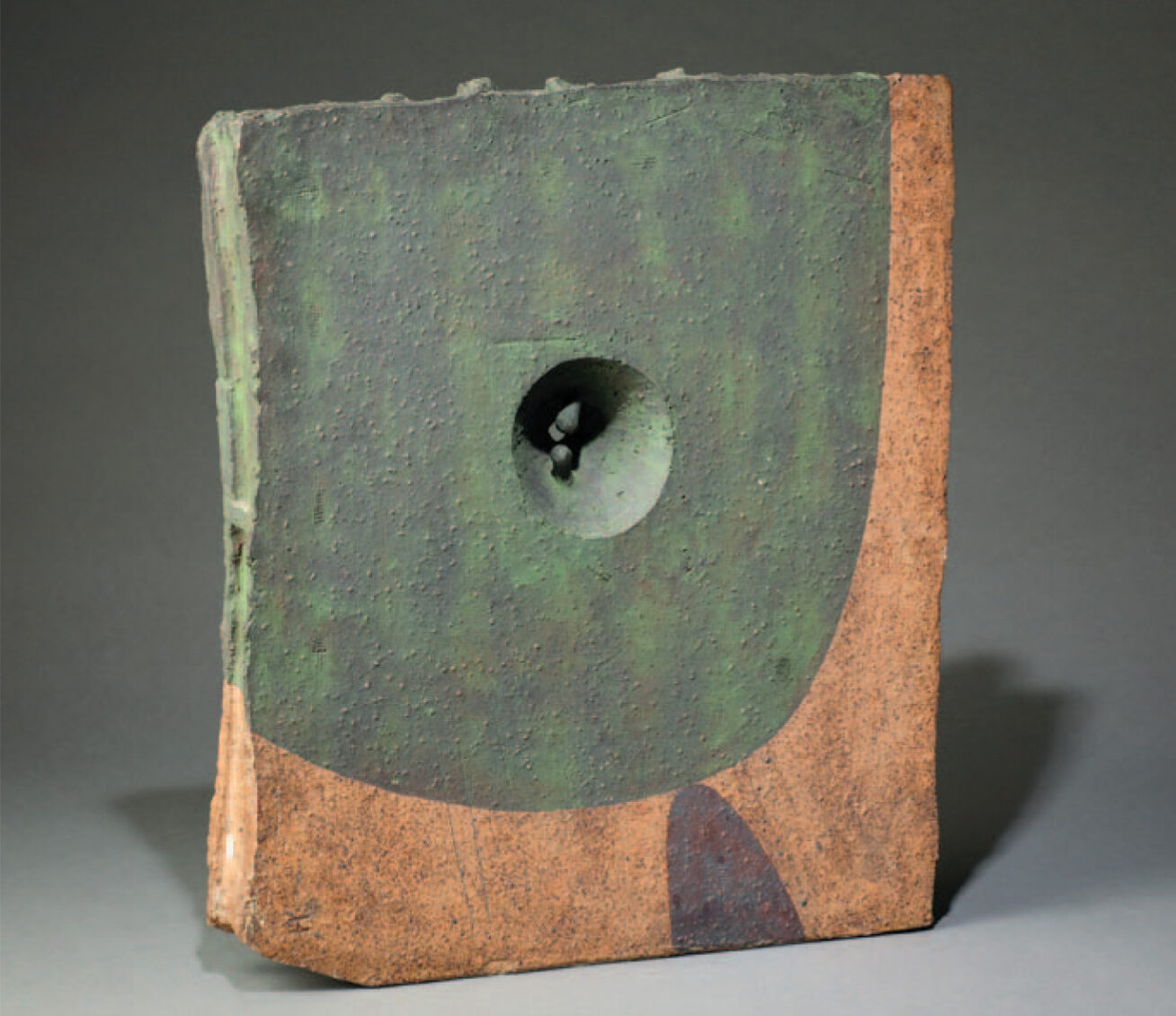 Photograph of a Japanese ceramic sculpture with a green glaze