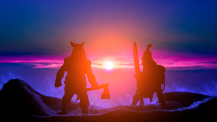 Image of two warriors backlit by the setting sun