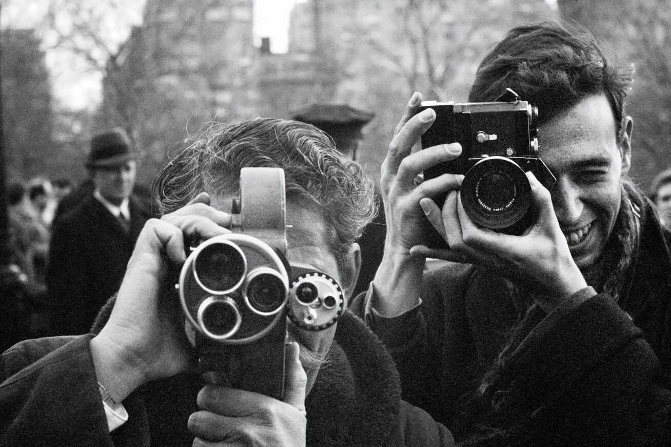 Black and white photograph of two photographers taking photos
