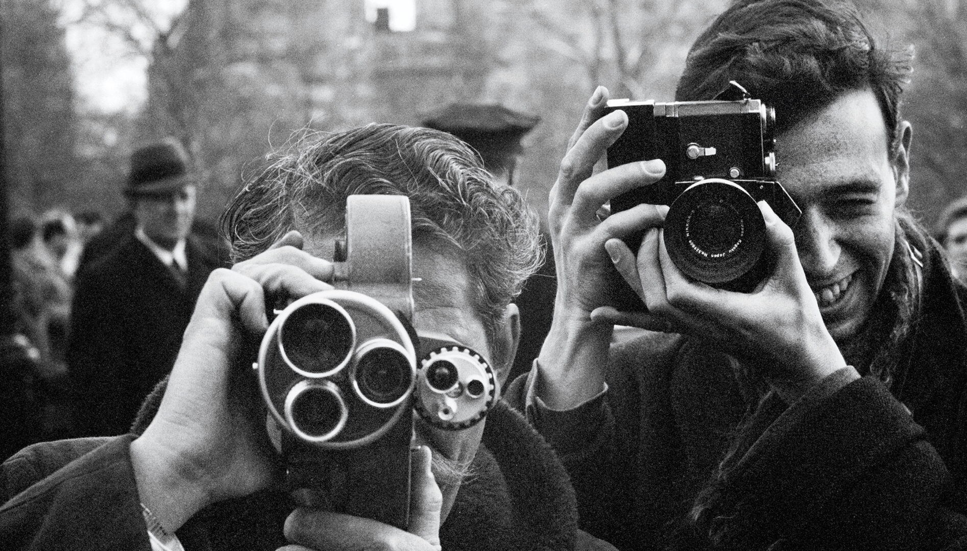 Black and white photograph of two photographers taking photos