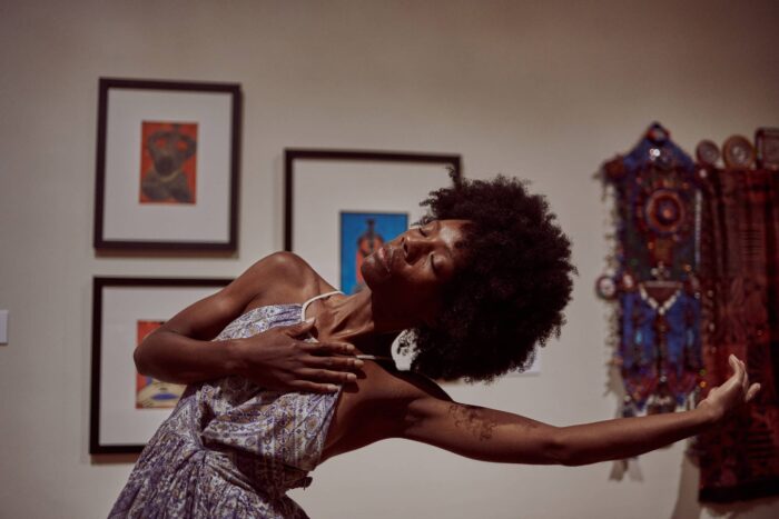 A person dancing in a gallery.