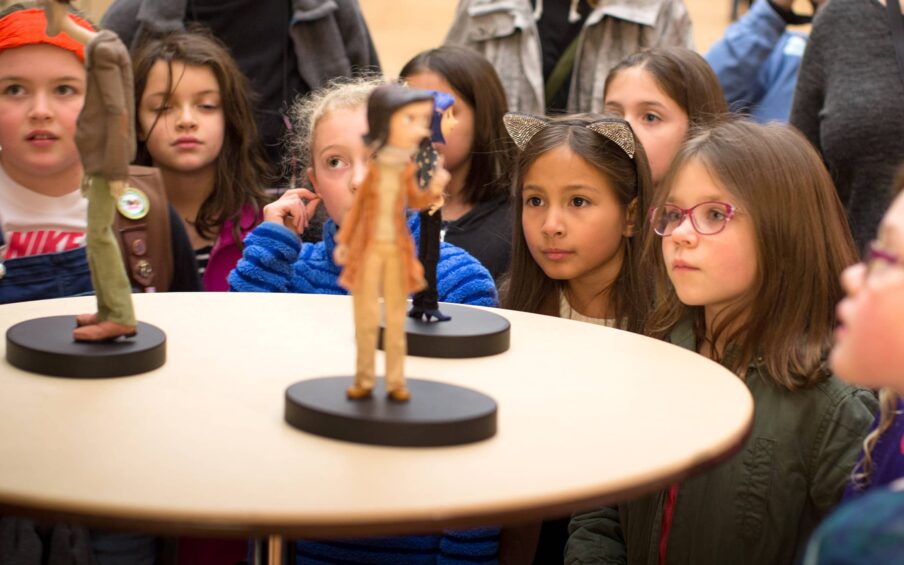 A group of children looking at animation models.