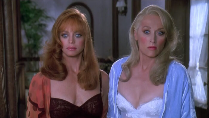Goldie Hawn and Meryl Street in lingerie with surprised looks on their faces