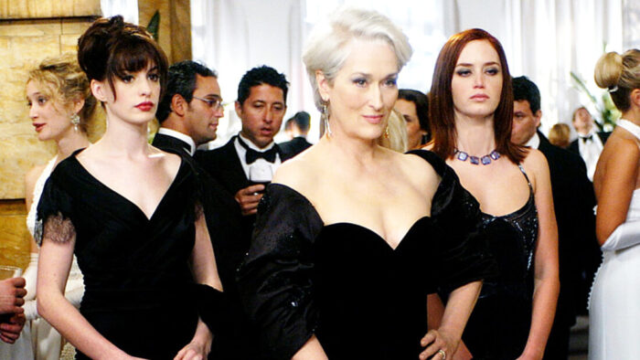 Photo of three woman in fancy black dresses at a party