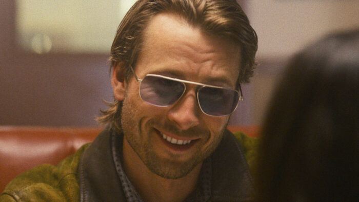 Photo of a blond man with aviator sunglasses on smiling