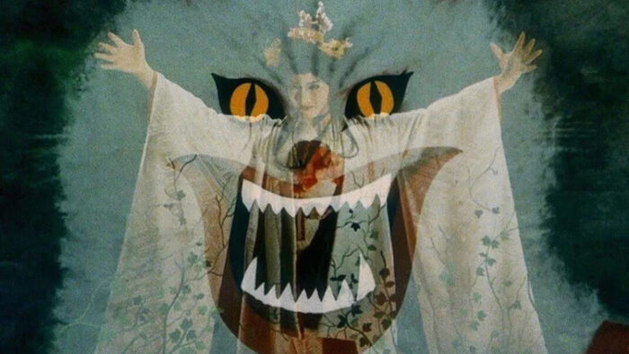 A film still of a woman in a white robe and a crown overlaid with an animated cat with yellow eyes and sharp teeth