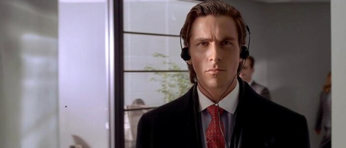 A white man in a suit with headphones on