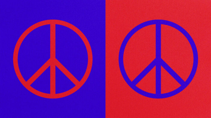 Two peace signs: one red on a blue background and one blue on a red background