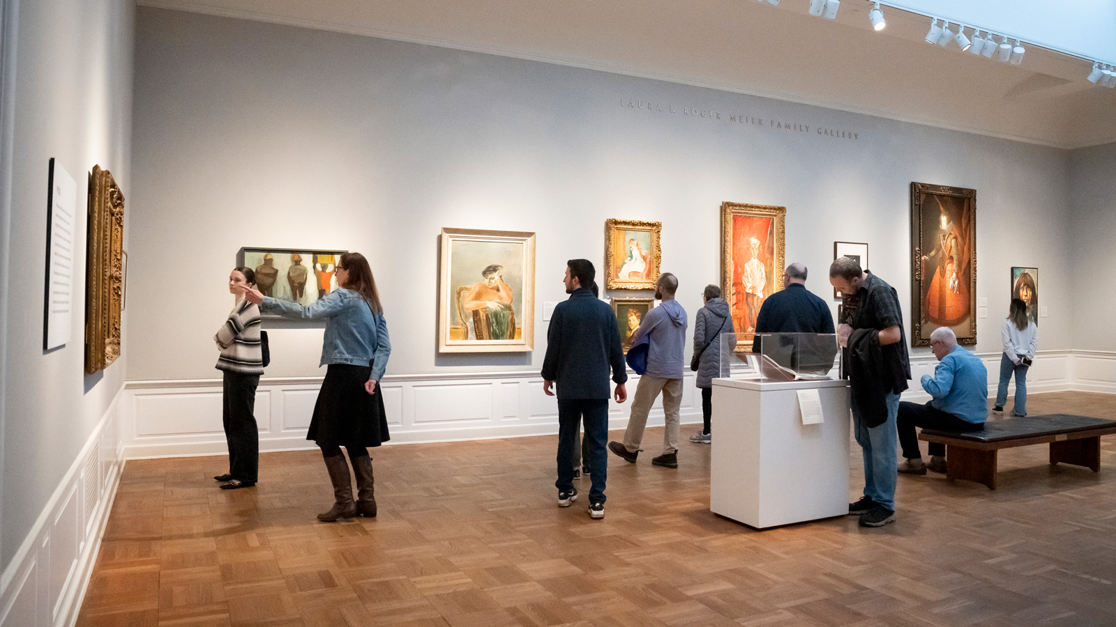 Photo of people looking at artwork in a gallery