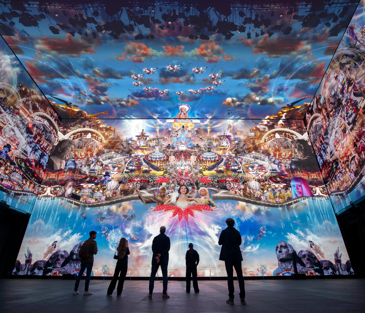 Installation view of a huge video collage with people in shadow at the bottom