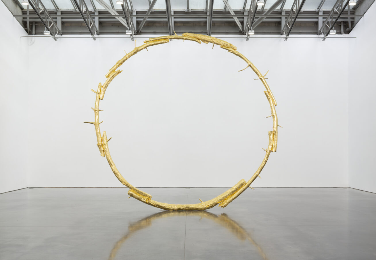 A large bronze sculpture in the shape of a ring.