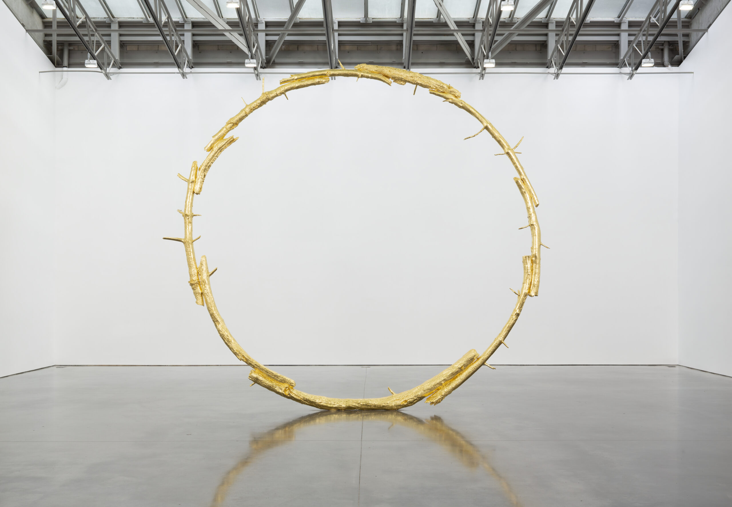 A large bronze sculpture in the shape of a ring.