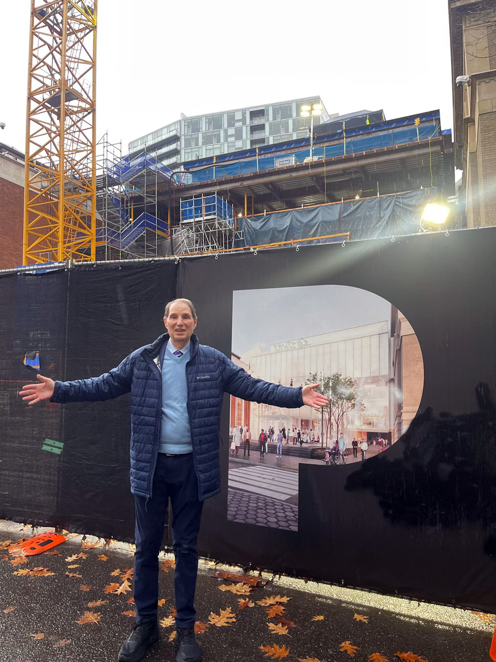 A man (Senator Ron Wyden) standing in front of a construction site