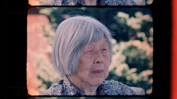 Film still of an old Chinese American woman with her hair in a grey bob