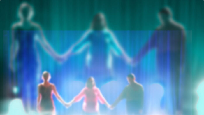 Blurred image of three people holding hands on a stage with strong lights below them. Larger projections of their bodies are shown behind them.