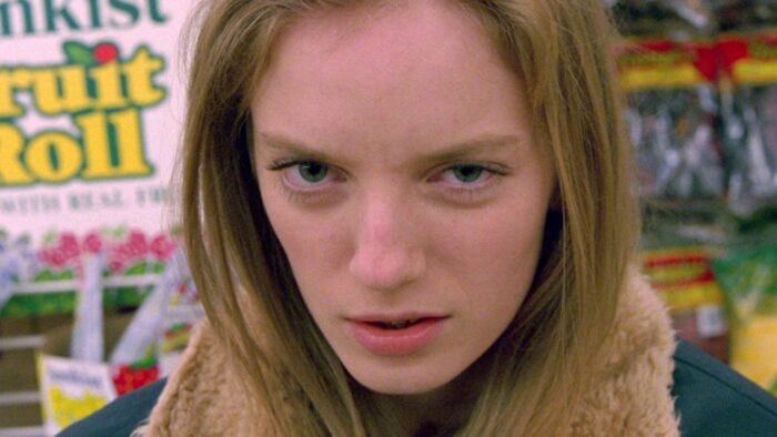 Close up film still of a young woman with blond hair