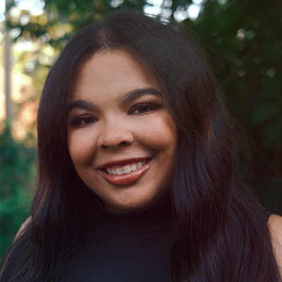Photo of a smiling woman with long brown hair