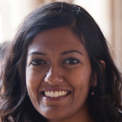 Photo of a smiling woman with long brown hair.
