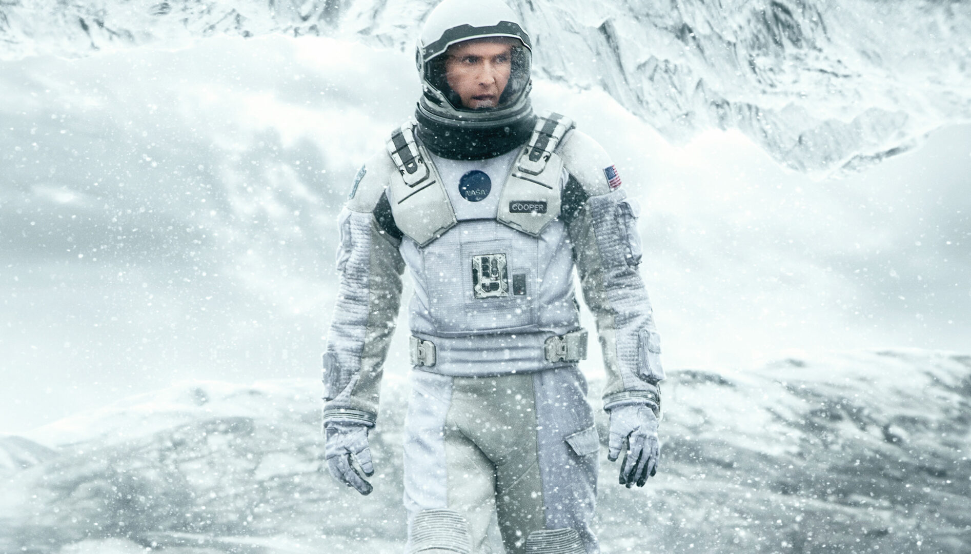 A man in a white astronaut suit surrounded by a white landscape