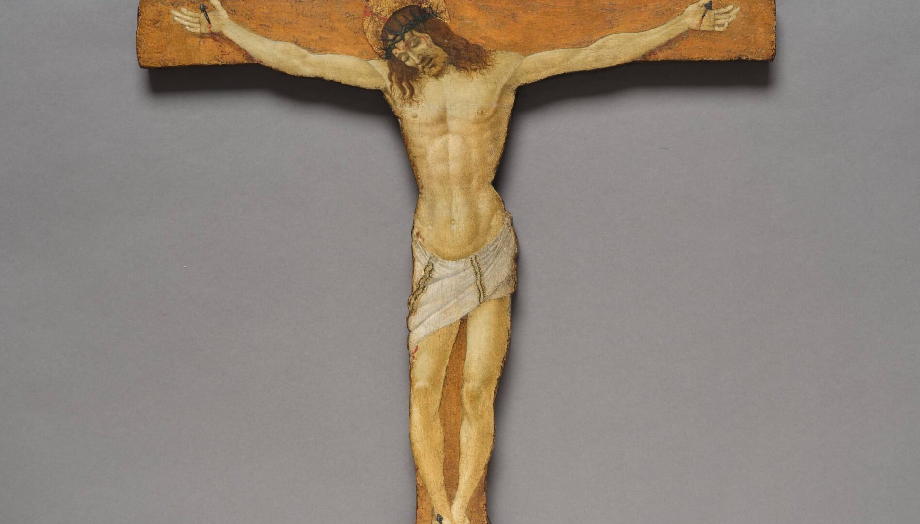 A painting of Christ's crucifixion on a wooden cross.