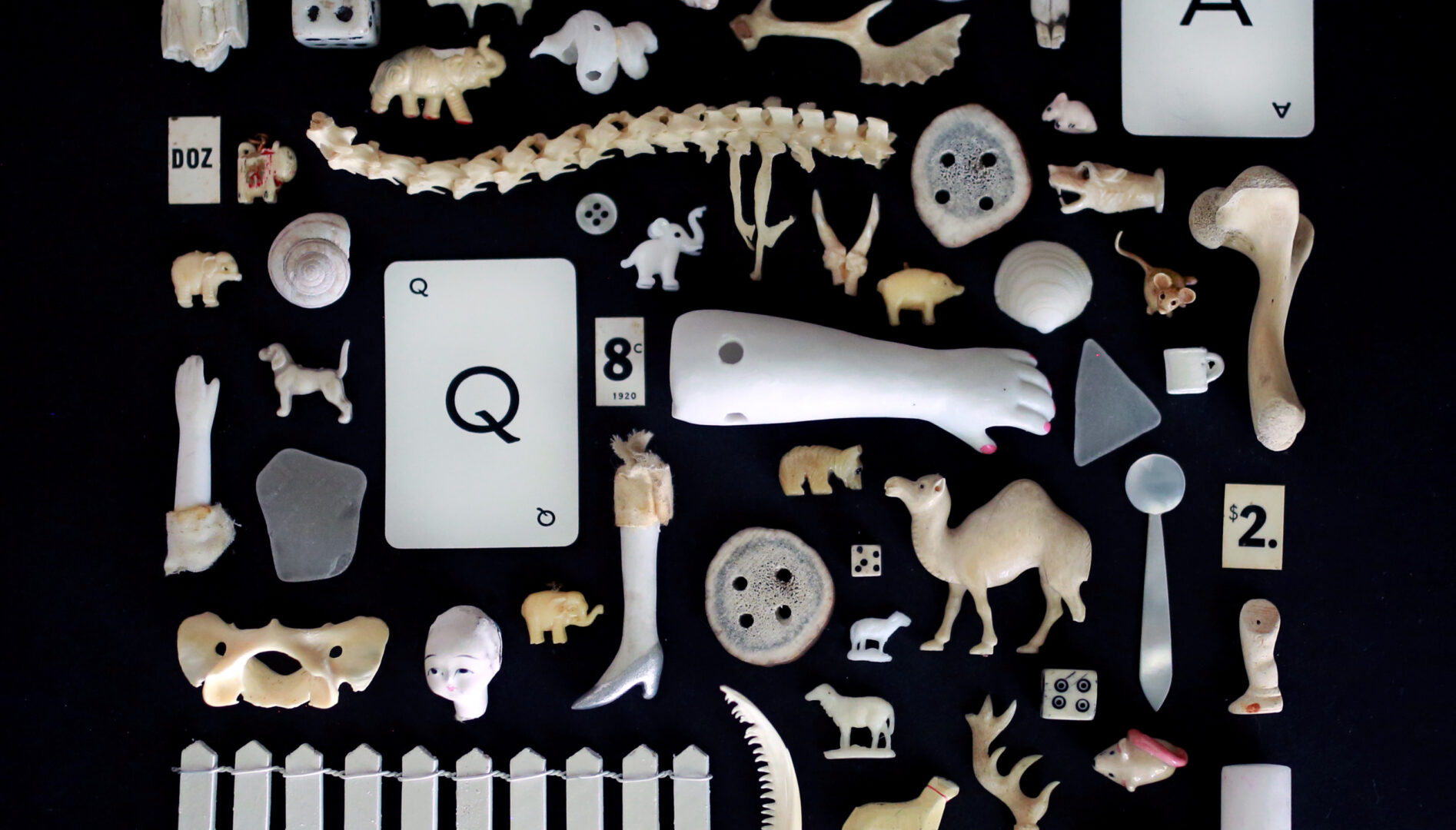 Photo of a collection of white and off-white objects on a black background