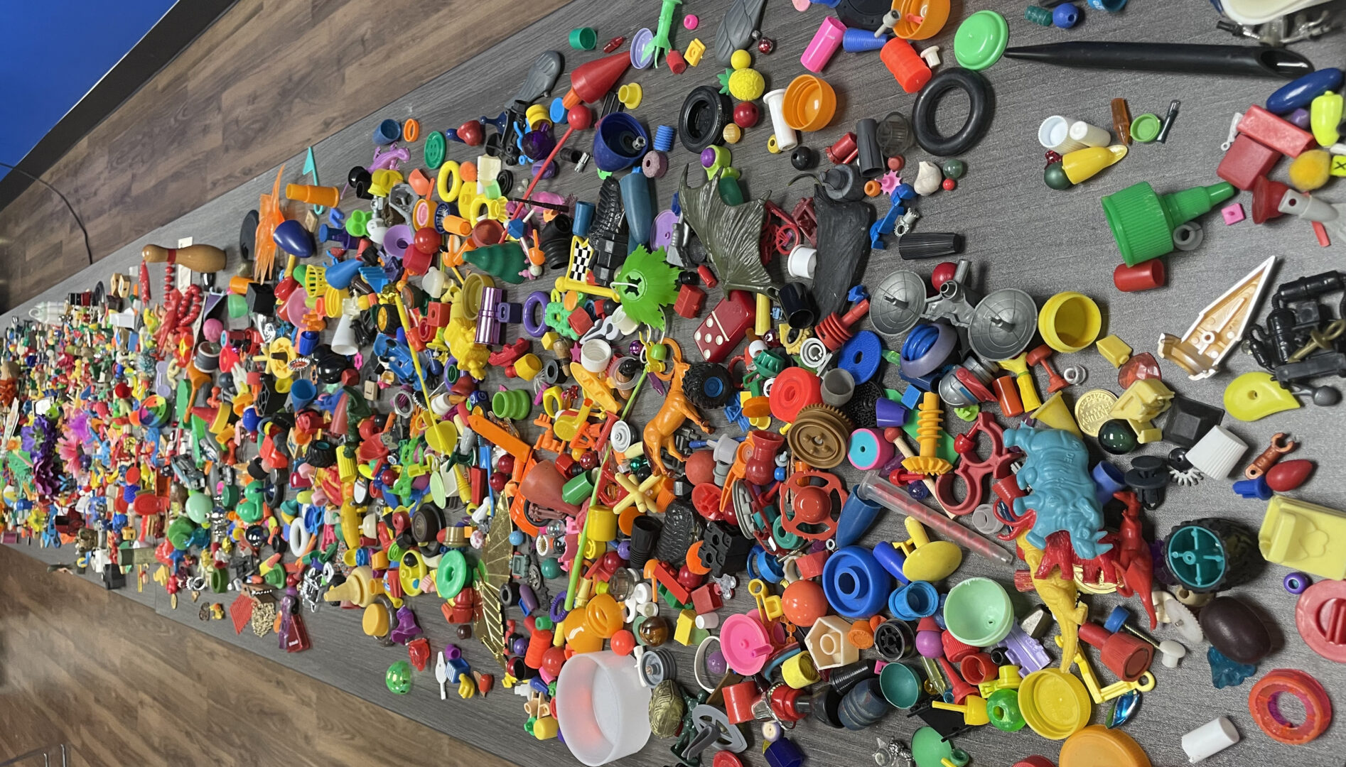 Photo of a wooden table with various small colorful objects on it