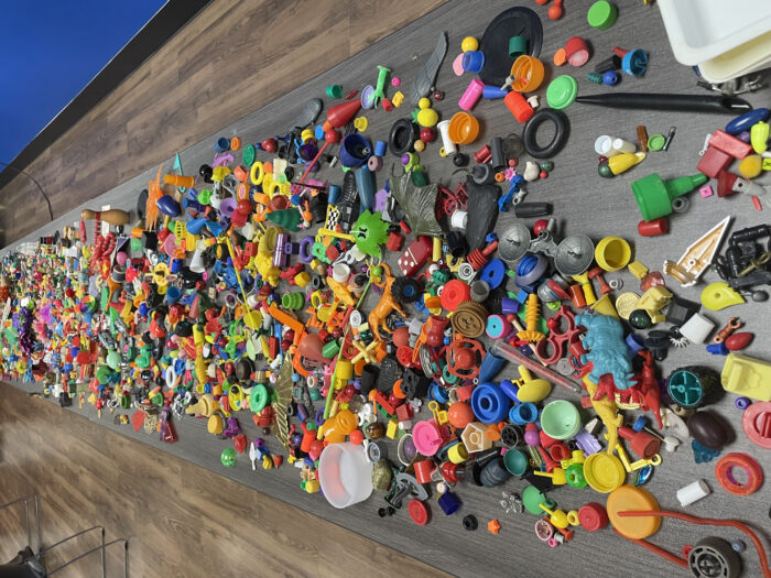 Photo of a wooden table with various small colorful objects on it