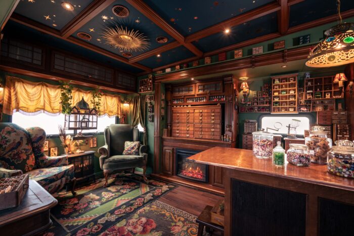 Interior of an old-fashioned room with fancy furnishings and curios on walls and tables.
