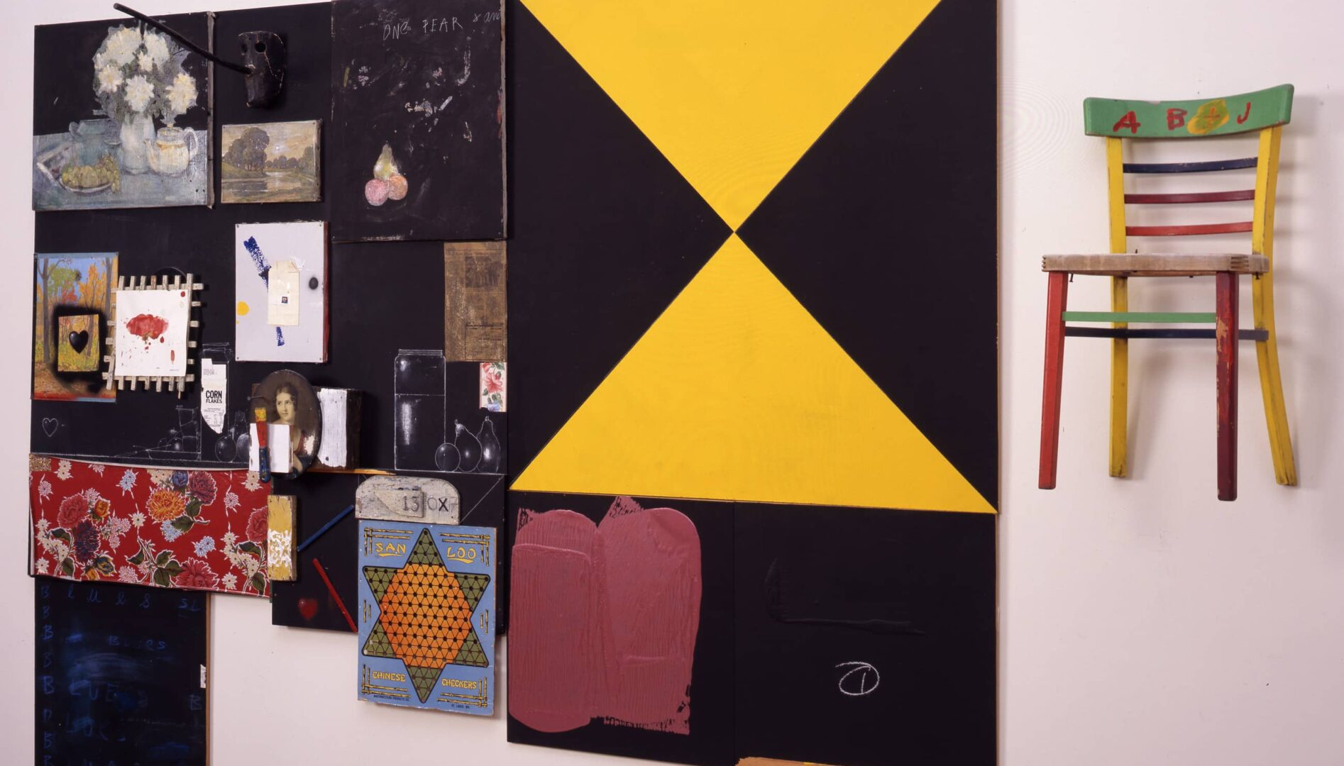 A multimedia art piece hanging on a gallery wall.